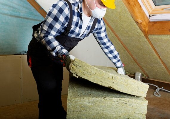 Man,Installing,Thermal,Roof,Insulation,Layer,-,Using,Mineral,Wool